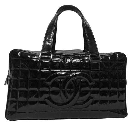 Chanel Chocolate Bar black patent leather quilted rectangular bowler tote by Karl Lagerfeld for Chanel 2003 with prominent interlocking CC front logo and 2 flat top handles, silver-tone hardware and feet. Dual Chanel engraved zipper closure with red microfiber lining and one zip pocket. Made in Italy 
