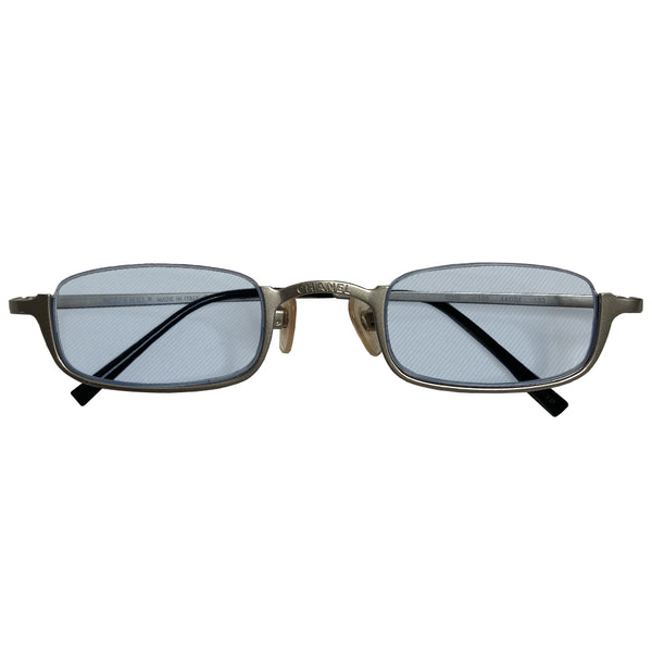 Chanel rimless lens CC logo sunglasses with brushed silver-tone lower half frame, arms with Chanel engraved at top of bridge and pale ice blue tinted rectangular lenses Style: 2009 c.103 Made in Italy