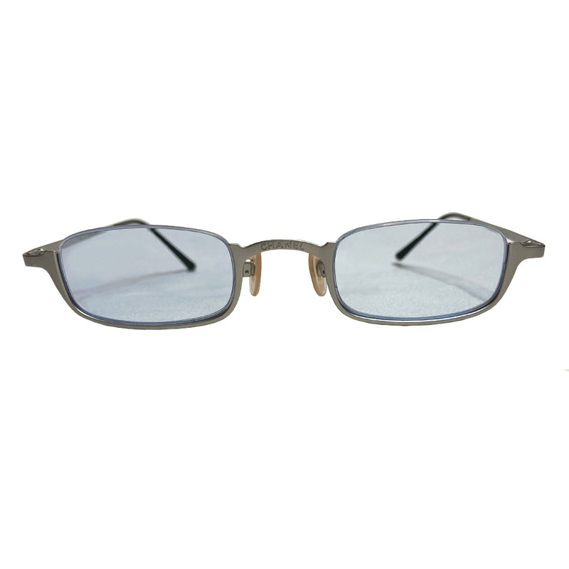 Chanel rimless lens CC logo sunglasses with brushed silver-tone lower half frame, arms with Chanel engraved at top of bridge and pale ice blue tinted rectangular lenses Style: 2009 c.103 Made in Italy