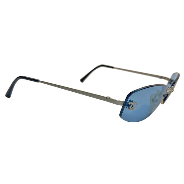 Chanel Blue Lens Frameless Sunglasses Circa 1990’s in excellent condition.  Rectangular blue rimless lenses with CC logo in silver on each lens. Arms: Silver-tone arm on each side Style: 4002 103/72   Made in Italy