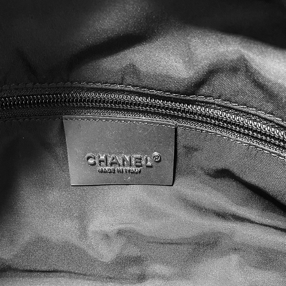 Chanel Sport bi-color grey canvas and black textured rubber canvas duffle/travel bag by Karl Lagerfeld for Chanel 2003/2004 with double zip closure, boxed rubber CC front logo. Double Chanel embossed adjustable satin webbing logo carry straps, logo padlock style black rubber zipper pulls, black nylon lining with single zip pocket. Made in Italy