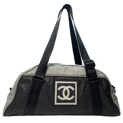 Chanel sport grey canvas and black textured rubber canvas duffle/travel bag by Karl Lagerfeld for Chanel 2003/2004 with double zip closure, boxed rubber CC front logo. Double Chanel embossed adjustable logo carry straps, logo padlock style black rubber zipper pulls, black nylon lining,single zip pocket. Made in Italy