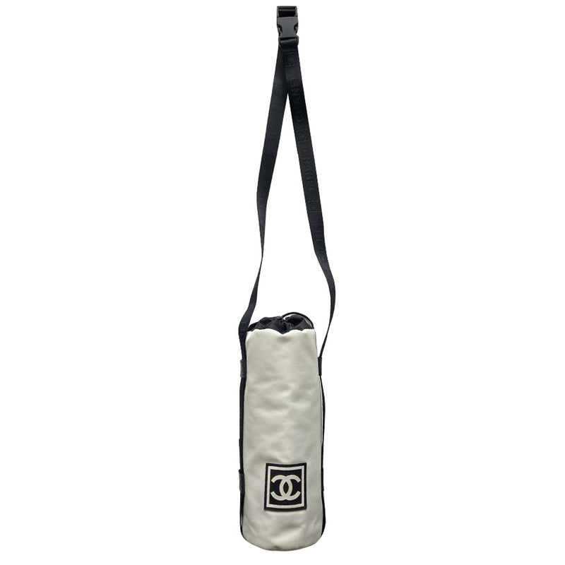Chanel Sport canvas CC logo draw string water bottle holder by Karl Lagerfeld for Chanel, sport collection 2004. White and black nylon fabric with side zipper and CHANEL nylon webbing, adjustable long strap with sport clip closure. Box CC rubber front logo, black textile interior, date code tag attached. Made in Italy 