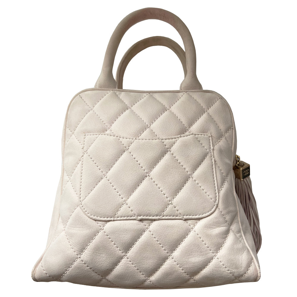 Chanel powder pink Mini Tassel Boston bag by Karl Lagerfeld for Chanel 2004. Rectangle suede quilted bowler bag with CC front logo and 2 rolled top handles, gold-tone feet on bottom. Top zipper closure with gold logo cube and tassel zipper pull, pink Chanel print lining, zip pocket. Outer rear slip pocket. Made in France 