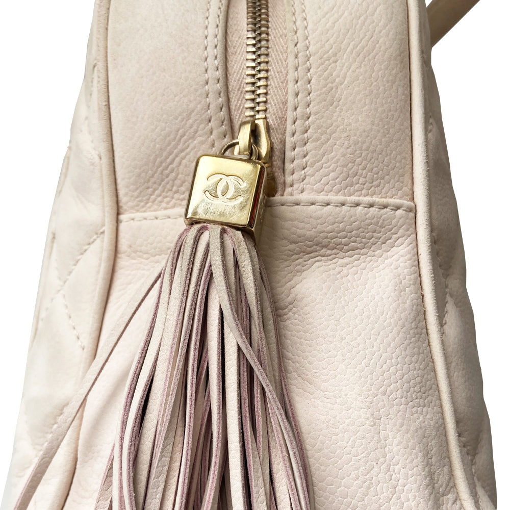 Chanel powder pink Mini Tassel Boston bag by Karl Lagerfeld for Chanel 2004. Rectangle suede quilted bowler bag with CC front logo and 2 rolled top handles, gold-tone feet on bottom. Top zipper closure with gold logo cube and tassel zipper pull, pink Chanel print lining, zip pocket. Outer rear slip pocket. Made in France 
