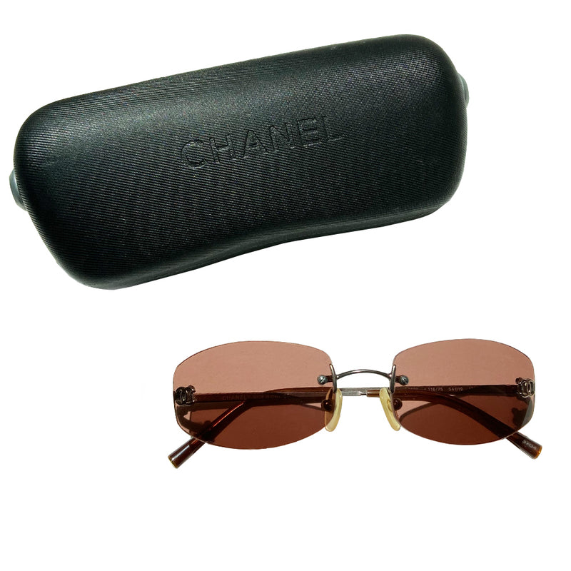 Chanel frameless brown oval lens CC logo sunglasses and silver-tone CC logo on each lens. Silver-tone metal arms with CC logo at the end of each arm. Style: 4002 c116/75 with case. No scratches on glasses, case in good condition Made in Italy
