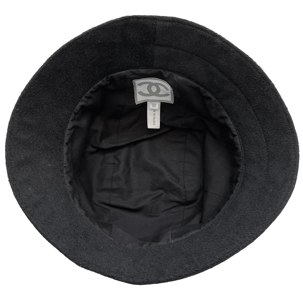 Chanel Logo Bucket Hat  From 2002 sport collection Terry cloth side panels with jersey center panel rounded bucket hat embellished with 2 black and white edged mesh bands dividing the panels Chanel and boxed CC logos printed in velvet on mesh bands Color: black with white  Size: M Fabric: Terry cloth, jersey, cotton interior  Made in France  Interior circumference (in)	22" Brim (in)	2.5"