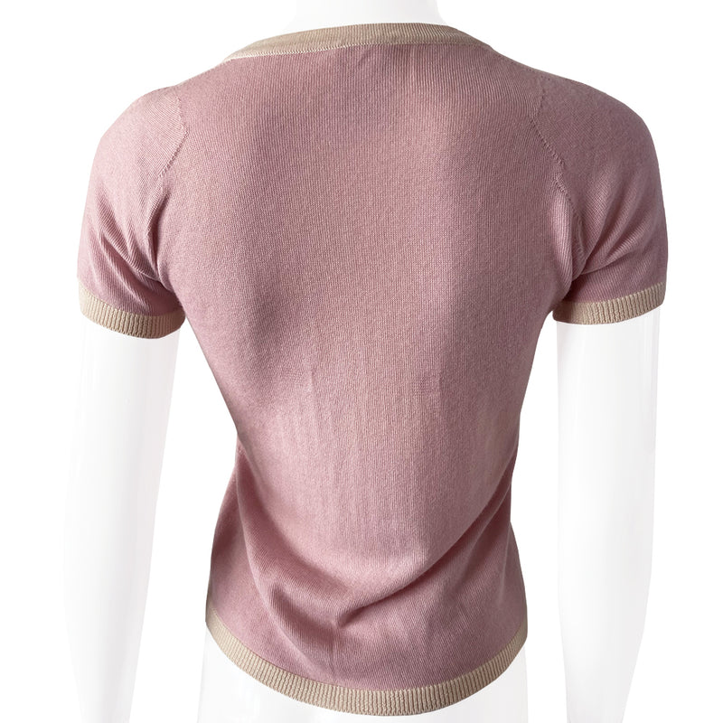 Chanel short sleeve pastel pink cashmere sweater Karl Lagerfeld for Chanel, 2004 with white accent and trim Interlocking CC logo at center chest and 2 front “faux” pockets. Size: FR 38 Made in Italy 