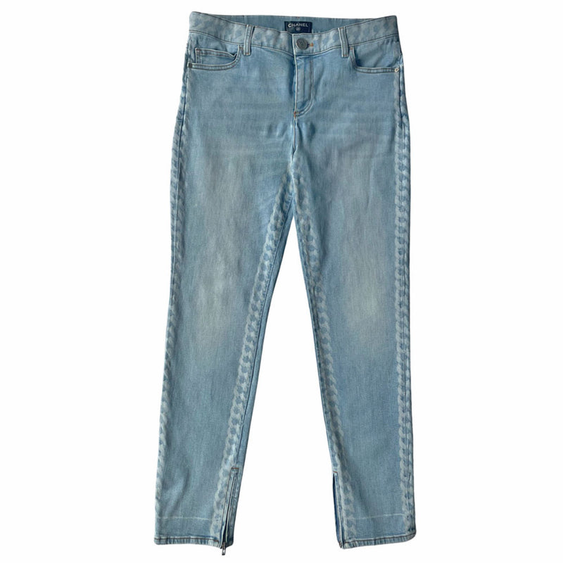 Chanel 2019 mid rise skinny faded wash 5 pocket stretch denim pants with faded white chain link design at waistband and down outer legs, CC engraved logo silver-tone rivets and top button, 5 " CC logo ankle zippers. Belt loops at waistband, calfskin leather diamond stitched CC logo patch at waistband. Made in Italy 