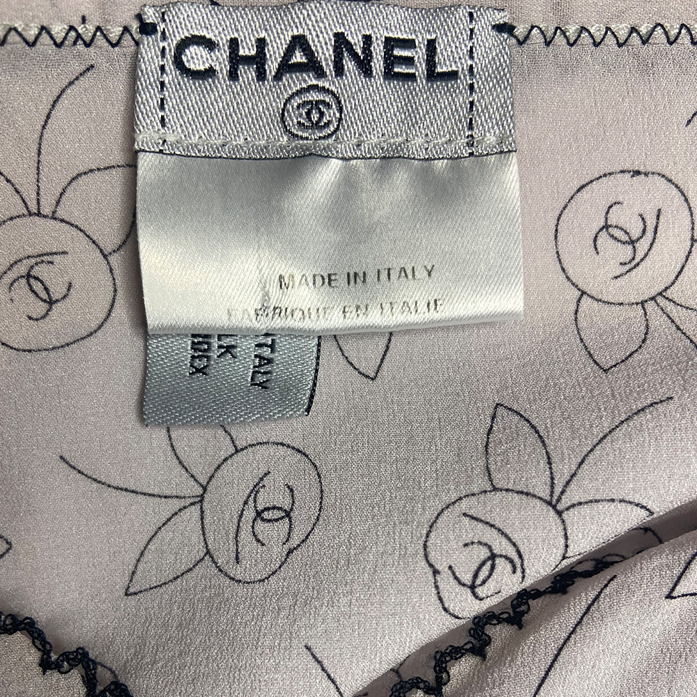 Chanel camellia blossom print soft silk camisole by Karl Lagerfeld for Chanel, Fall 2003 featuring all over camellia blossoms with CC logo centers. Triangle shaped black lace trim on straps and along back with decorative embroidered décolletage and bottom hemline. Made in Italy 
