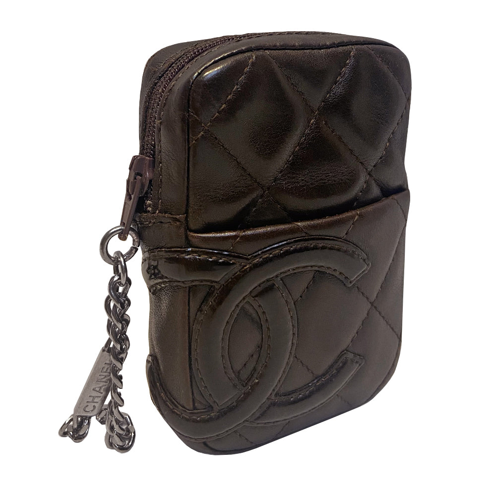 Chanel Cambon quilted brown leather cigarette case by Karl Lagerfeld for Chanel, circa 2004-2005 with outer slip pocket, tonal interlocking CC logo stitched appliqué. Rear leather belt loop, top zip closure with silver-tone metal logo engraved chain zipper pull. Orange CC logo textile lining Interior. Made in France 