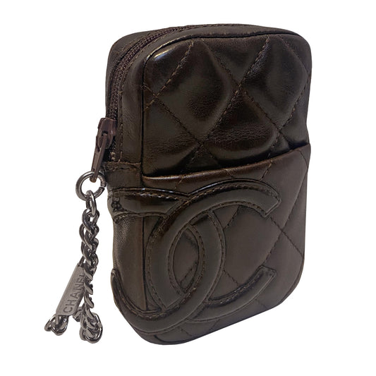 Chanel Cambon quilted brown leather cigarette case by Karl Lagerfeld for Chanel, circa 2004-2005 with outer slip pocket, tonal interlocking CC logo stitched appliqué. Rear leather belt loop, top zip closure with silver-tone metal logo engraved chain zipper pull. Orange CC logo textile lining Interior. Made in France 