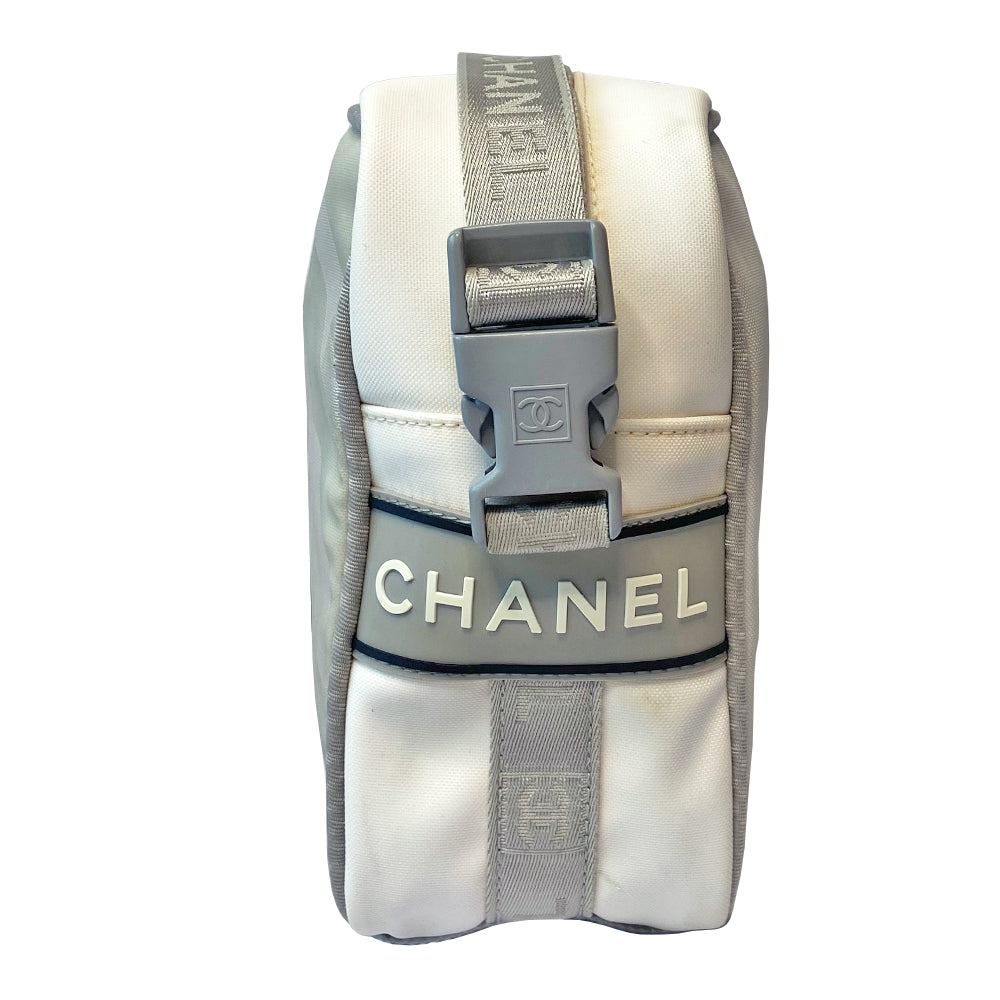 Chanel grey with silver Sport Line nylon canvas rectangular cross body messenger bag by Karl Lagerfeld for Chanel, 2001 with angled box front CC logo, rubber CHANEL side logos, grey piping and long sating webbing logo removable shoulder strap. Top ziper with grey textile interior and inside slip pocket. Made in Italy 