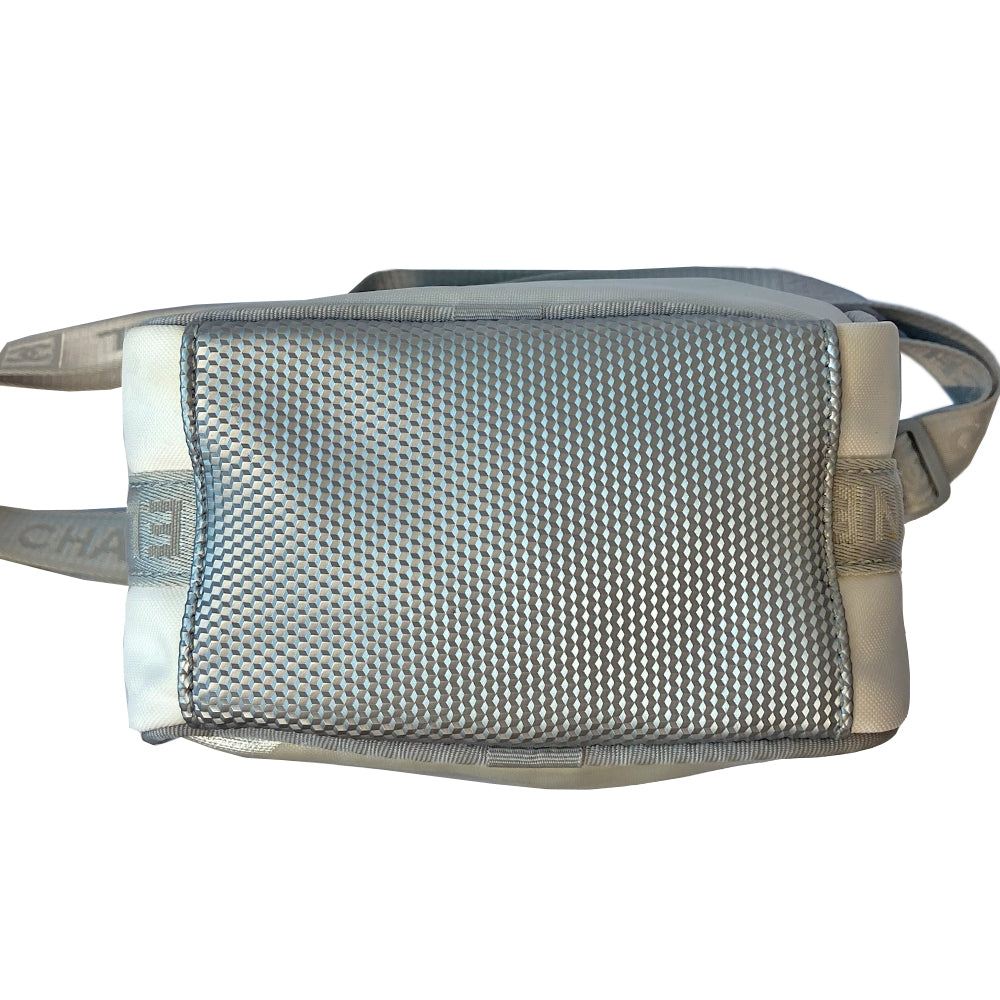 Chanel grey with silver Sport Line nylon canvas rectangular cross body messenger bag by Karl Lagerfeld for Chanel, 2001 with angled box front CC logo, rubber CHANEL side logos, grey piping and long sating webbing logo removable shoulder strap. Top ziper with grey textile interior and inside slip pocket. Made in Italy 
