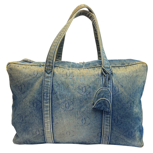 Chanel all over CC logo distressed denim overnight bag by Karl Lagerfeld for Chanel 2003 with detachable key pouch, outer slip pocket, dual zip closure, double carry handles. Jacquard textile CC logo print lining with zippered pocket, elastic compression straps to hold items in place. Serial number sticker attached. 