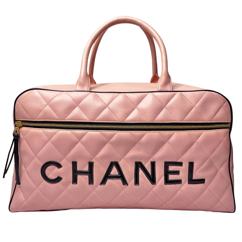 Chanel pink diamond quilted leather boston bag by Karl Lagerfeld for Chanel 1995  with contrasting black leather piping, trim and stitched CHANEL letters front logo. Gold tone zippers and feet, exterior zip pocket, top zipper closure, lack leather interior with one interior zip pocket. Made in France