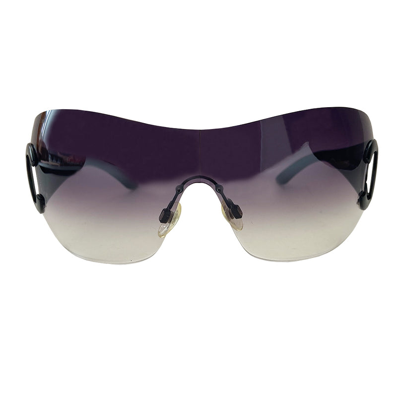 Chanel CC logo oversized shield frameless sunglasses with gradient lavender lens and black acetate arms. Black CC cutout black metal CC logo at side hinges. Style: 4124. Made in Italy 