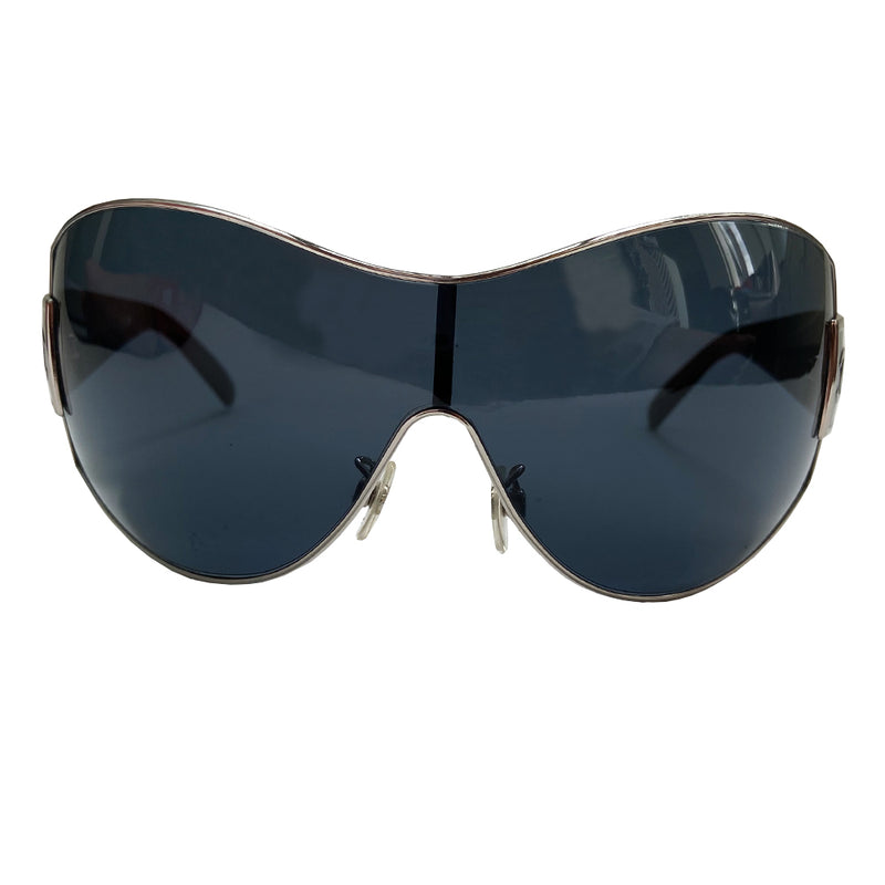 Chanel Oversized Shield Sunglasses with oversized lens surrounded by silver-tone metal frame, wide arms, square CC silver logo at sides that wrap on to the lens Condition: Excellent, no scratches on lens. Main Color: Black with black lens Case and dust cover included. Made in Italy. 