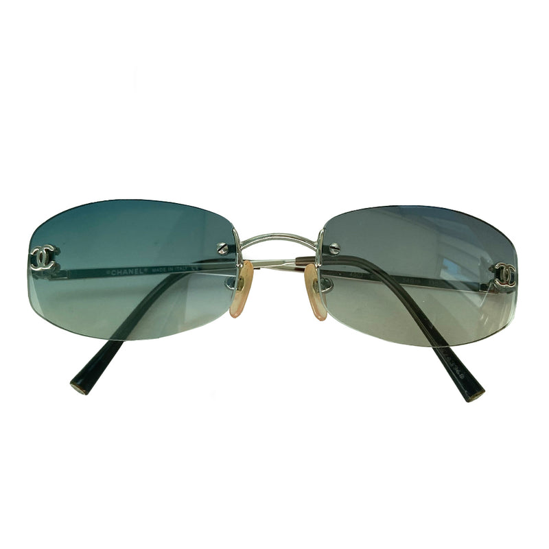 Chanel blue gradient lens frameless logo sunglasses with rectangular shaped gradient blue rimless lenses and CC logo in silver on each lens.  Silver-tone arms with CC logo at the tip of each arm.  Hard case included.  Made in Italy 