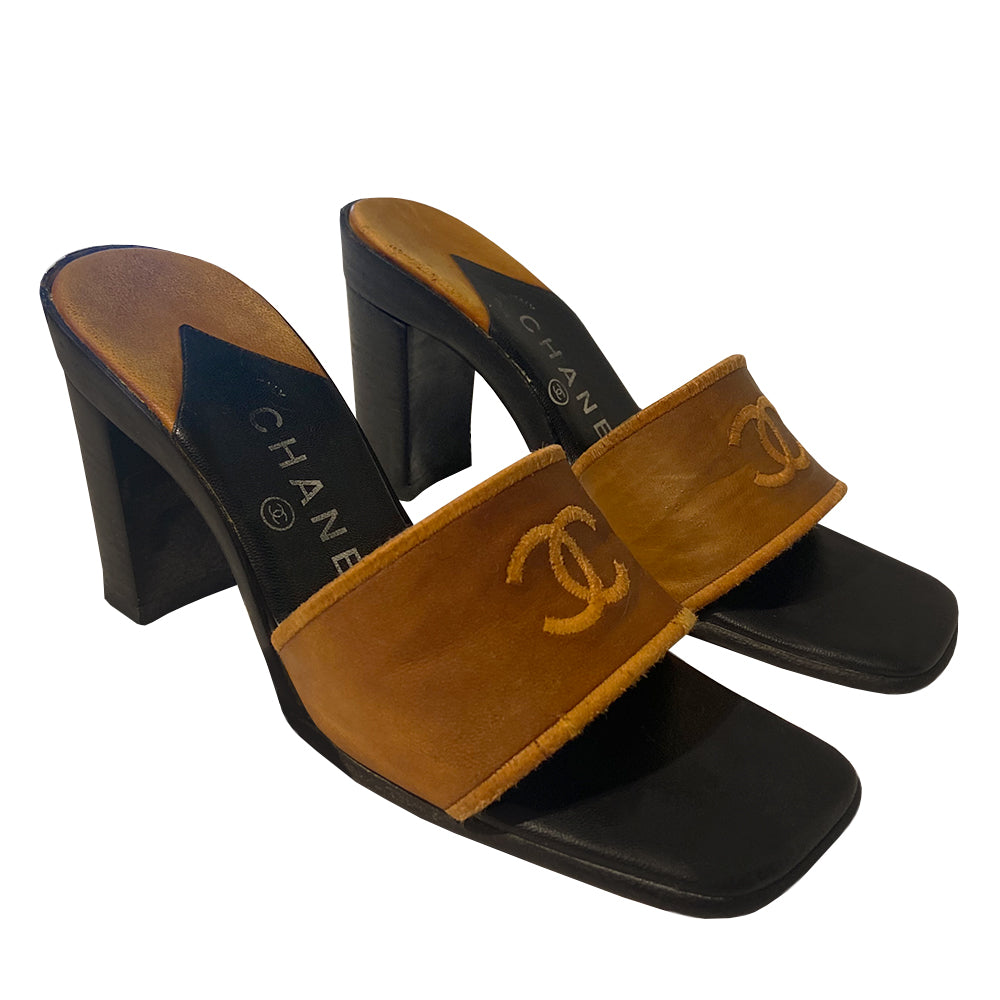 Chanel CC Logo tobacco color leather slip-on open toe heeled mules with embroidered interlocking CC logo on upper. Made in Italy
