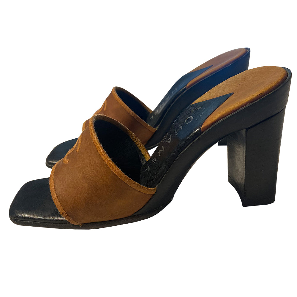 Chanel CC Logo tobacco color leather slip-on open toe heeled mules with embroidered interlocking CC logo on upper. Made in Italy