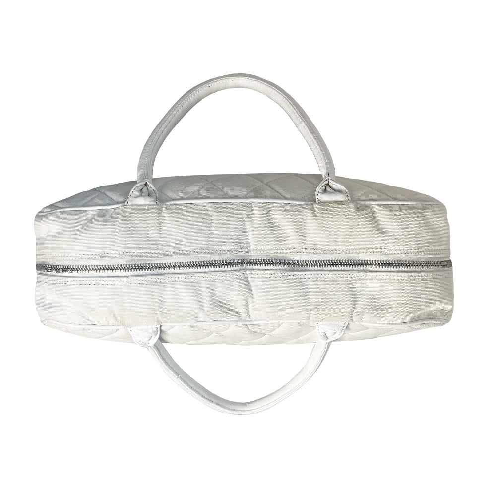 Chanel Logo white canvas quilted bowler by Karl Lagerfeld for Chanel 2001 with rolled leather handles, leather piping and grey leather, front CHANEL logo letters. Silver-tone top zip closure with CC logo grey rubber zipper pulls, Chanel logo rubber protective feet. White textile lining, one open leather pocket. Made in Italy