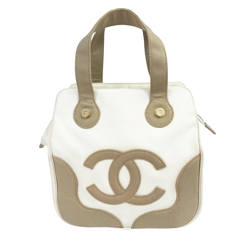 Chanel canvas Marshmallow Tote by Karl Lagerfeld for Chanel 2003-2004. White canvas tote with taupe handles and accent, stitched interlocking CC front logo, protective bottom feet. Gold-tone top zipper and hardware Chanel printed textile interior with one interior zip pocket. Made in Italy 
