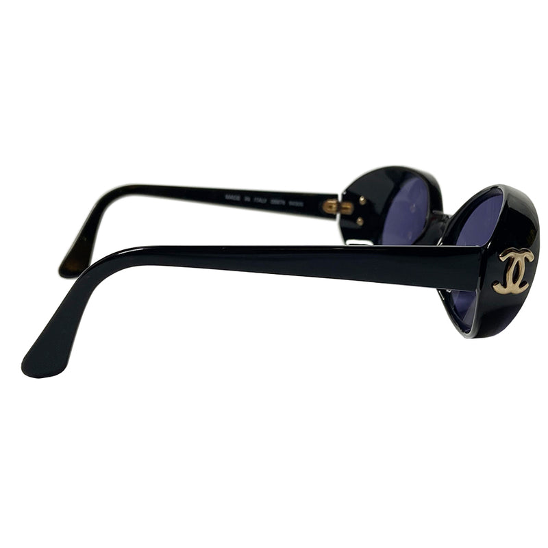 Chanel oval black acetate frame goggle style sunglasses by Karl Lagerfeld for Chanel 1990’s with interlocking CC gold logos at temple. Dark grey lenses.  Style: 05976 Case included. Made in Italy