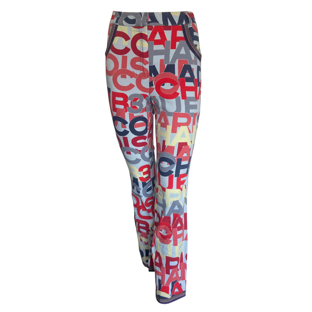 Chanel Identification Collection high rise graphic letters denim pants from Karl Lagerfeld for Chanel, 2000 with panel details at back hemline, zip fly with hook closure, bold all over colorful lettering spell out CHANEL, COCO, PARIS. Striped knit accent at front pockets and bottom hem. Made in Italy 