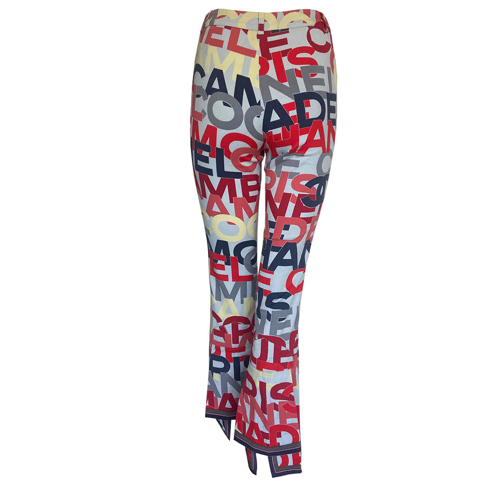 Chanel Identification Collection high rise graphic letters denim pants from Karl Lagerfeld for Chanel, 2000 with panel details at back hemline, zip fly with hook closure, bold all over colorful lettering spell out CHANEL, COCO, PARIS. Striped knit accent at front pockets and bottom hem. Made in Italy 