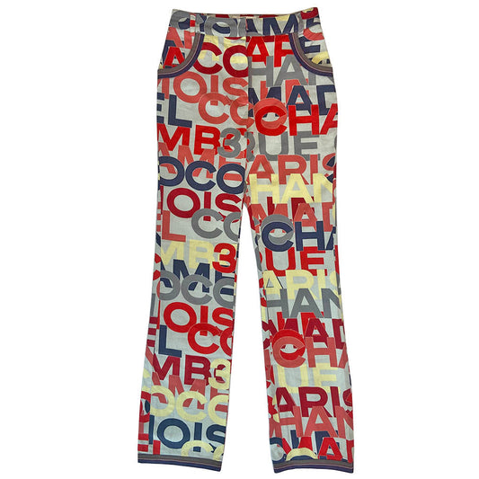 Chanel Identification Collection high rise graphic letters denim pants from Karl Lagerfeld for Chanel, 2000 with panel details at back hemline, zip fly with hook closure, bold all over colorful lettering spell out CHANEL, COCO, PARIS. Striped knit accent at front pockets and bottom hem. Made in Italy 