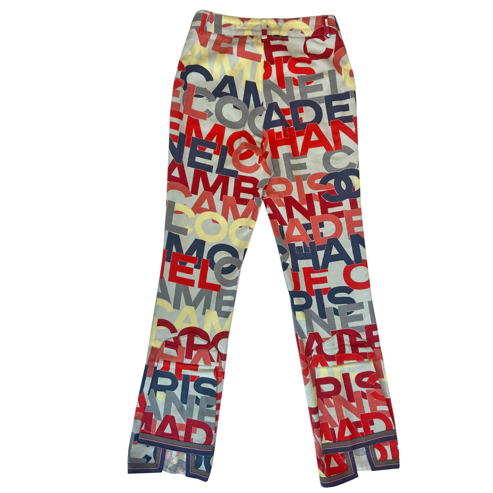 Chanel Identification Collection high rise graphic letters denim pants from Karl Lagerfeld for Chanel, 2000 with panel details at back hemline, zip fly with hook closure, bold all over colorful lettering spell out CHANEL, COCO, PARIS. Striped knit accent at front pockets and bottom hem. Made in Italy 