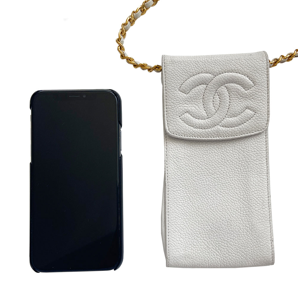 Chanel white caviar mini cross body cigarette/cellphone bag by Karl Lagerfeld for Chanel, circa 1994-1996 with stitched interlocking CC logo flap top with intertwined leather and gold-tone long chain strap. Chanel logo stamped inside leather interior Date code sticker intact. Made in Italy 