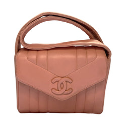 Chanel pink vertical quilt lamb leather bag by Karl Lagerfeld for Chanel, 1995 with envelope magnetic flap closure, interlocking CC raised leather front logo, rear outer slip pocket, long vertical quilted leather shoulder strap. Matching pink leather lining, slip pocket and grosgrain lined zippered pocket with gold medallion zipper pull. Made in France 