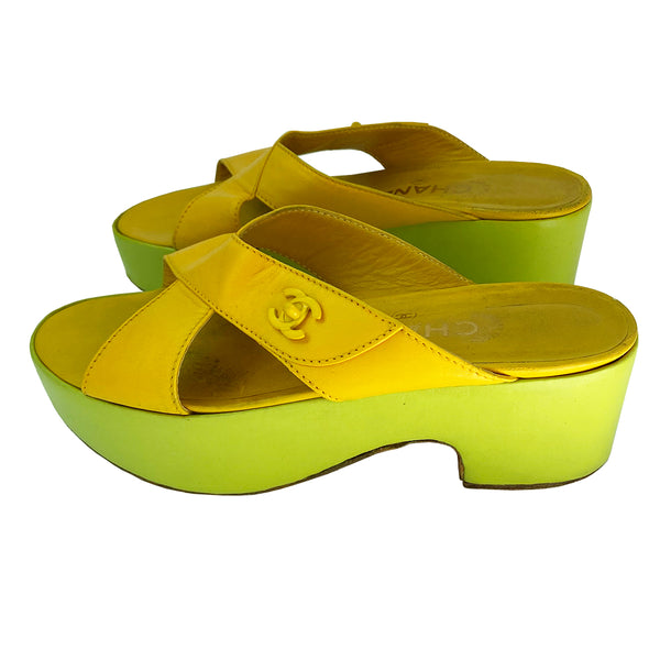 Chanel Lemon-Lime two tone lamb leather platform open toe slip on sandals circa 2002.  2” platform with small heel. Bright yellow criss-cross upper with tonal accent stitching and signature Mademoiselle lock adornment and lime green platform. Size: IT 38 Some visible scuffing. Made in Italy 