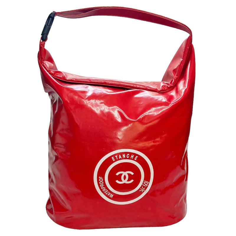 Chanel red vinyl tote by Karl Lagerfeld for Chanel 2000-2002 with matching vinyl handle that clips at one end White CC printed center front logo. Folding top access to large capacity open vinyl interior. Made in France 