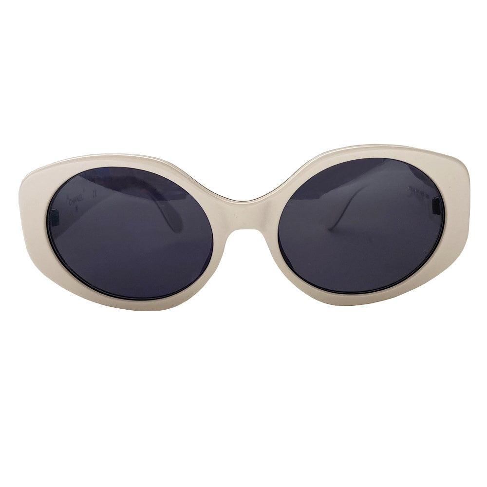 Chanel white acetate frame sunglasses by Karl Lagerfeld for Chanel circa 1995 with thick side arms and dark charcoal lenses Interlocking gold-tone CC logos at each arm, black pinstripe detail on frame and arm edges. Style: 08850 C0200. Made in Italy 
