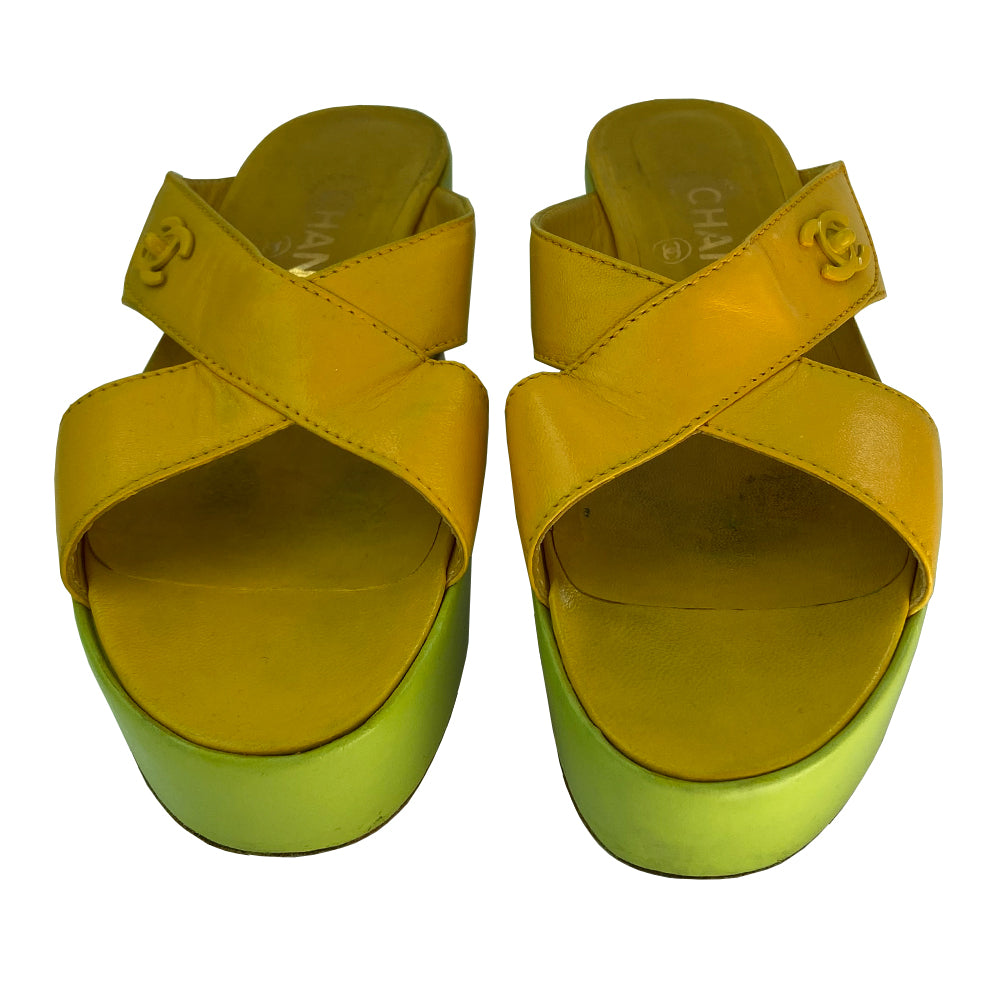 Chanel Lemon-Lime two tone lamb leather platform open toe slip on sandals circa 2002.  2” platform with small heel. Bright yellow criss-cross upper with tonal accent stitching and signature Mademoiselle lock adornment and lime green platform. Size: IT 38 Some visible scuffing. Made in Italy 