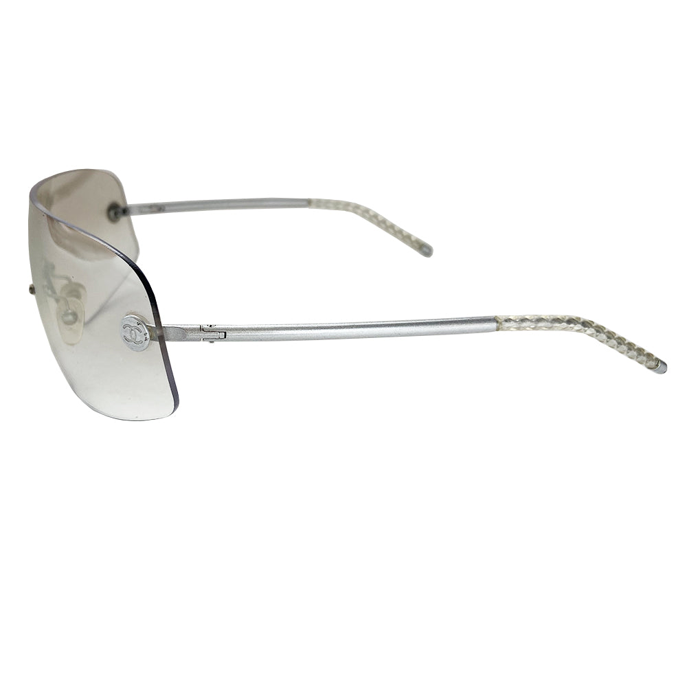 Chanel smoke to clear gradient lens shield sunglasses interlocking silver-tone CC logos at lens edges and silver-tone arms with twisted end pieces Style: 4036 Made in Italy 