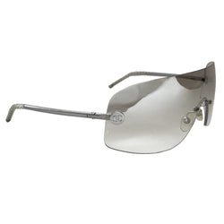 Chanel smoke to clear gradient lens shield sunglasses interlocking silver-tone CC logos at lens edges and silver-tone arms with twisted end pieces Style: 4036 Made in Italy 