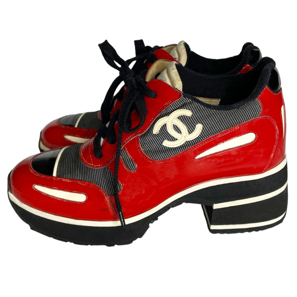 Chanel red with white patent block heel platform lace up sneakers by Karl Lagerfeld for Chanel, SS 1997 runway with nylon fabric inserts and tongue with CHANEL logo, white leather CC stitched logos on either side. Black rubber platform with white  stripe & black with white stripe stacked rubber block heel, Chanel logo treaded sole. Made in Italy 