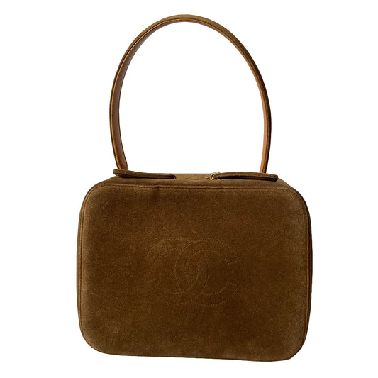 Chanel tobacco suede vanity case by Karl Lagerfeld for Chanel 1997-1999. Rectangular top handle bag with interlocking stitched CC logo at front, dual suede paddle zipper pull closure, chocolate leather interior with one zippered pocket and one slip pocket. Serial number sticker attached. Made in Italy