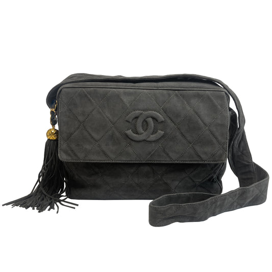Chanel quilted CC logo crossbody charcoal grey shoulder bag with suede strap by Karl Lagerfeld for Chanel, 1995 with etched gold ball and tassels zipper pull, outer flap pocket with black leather lining, interior zippered pocket. Made in France
