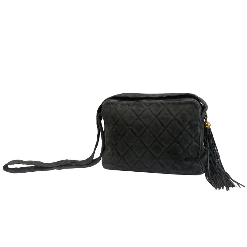 Chanel quilted CC logo crossbody charcoal grey shoulder bag with suede strap by Karl Lagerfeld for Chanel, 1995 with etched gold ball and tassels zipper pull, outer flap pocket with black leather lining, interior zippered pocket. Made in France