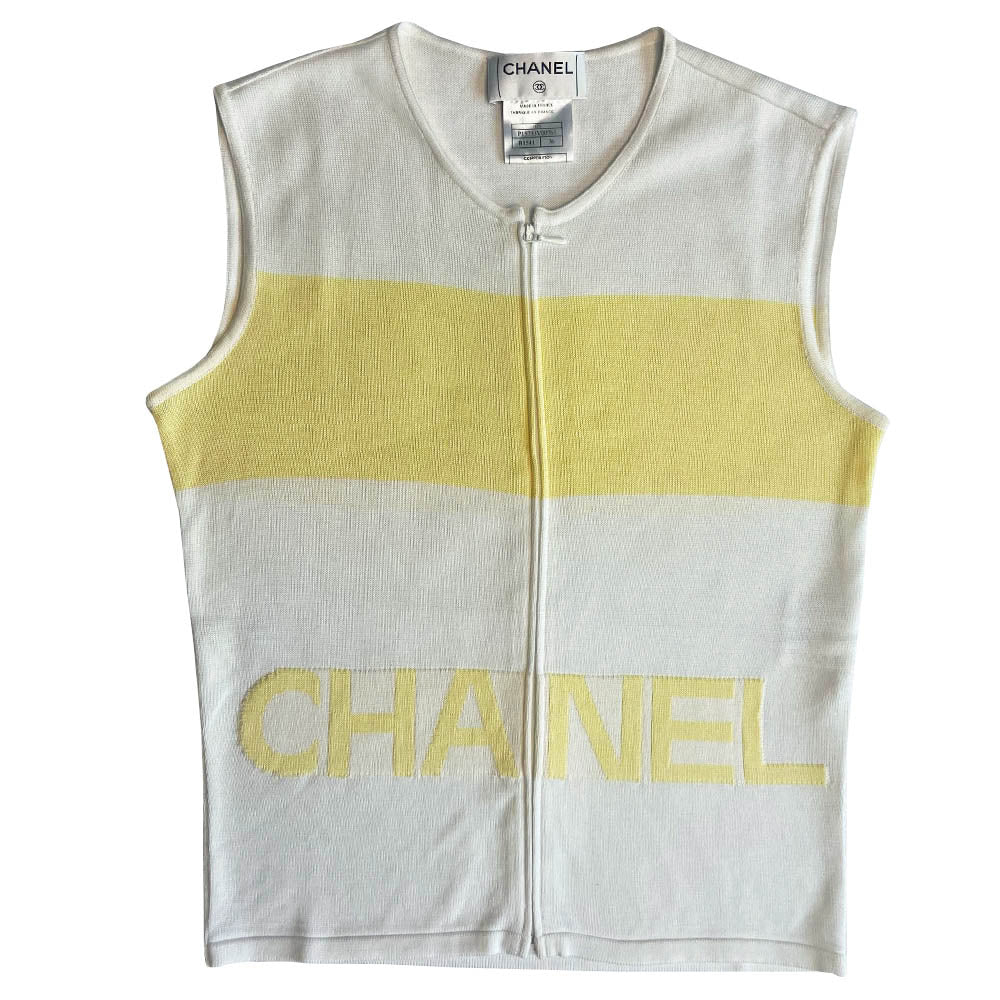Chanel logo sleeveless front zip white with pale yellow color block knit top by Karl Lagerfeld for Chanel, Spring 2000 with CHANEL logo panel across front torso. Made in France 