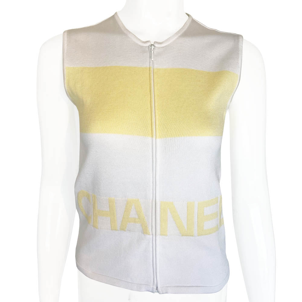 Chanel logo sleeveless front zip white with pale yellow color block knit top by Karl Lagerfeld for Chanel, Spring 2000 with CHANEL logo panel across front torso. Made in France 