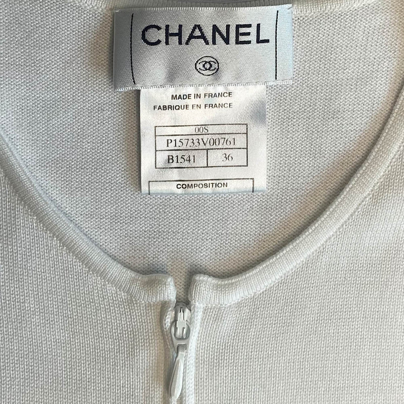 Chanel logo sleeveless front zip white with pale yellow color block knit top by Karl Lagerfeld for Chanel, Spring 2000 with CHANEL logo panel across front torso. Made in France 