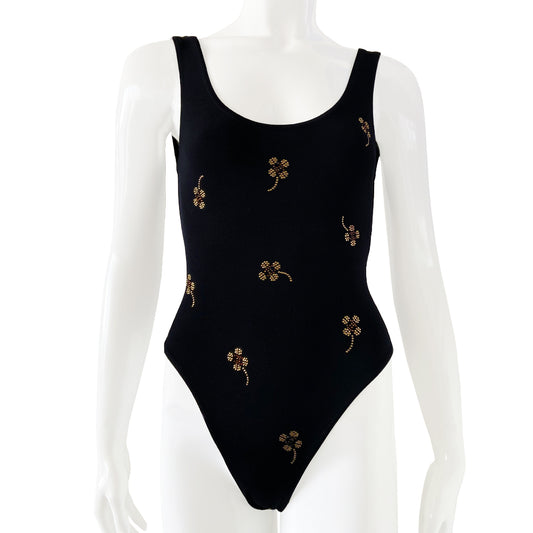 Chanel crystal appliqué embellished clover one-piece swimsuit by Karl Lagerfeld for Chanel 2001 Cruise Collection. Solid black stretch grosgrain fabric one-piece swimsuit with low back, front embellishments of tiny gold and bronze-tone appliqué crystal cc logo clovers and single logo clover in back. Size 36.  Made in France