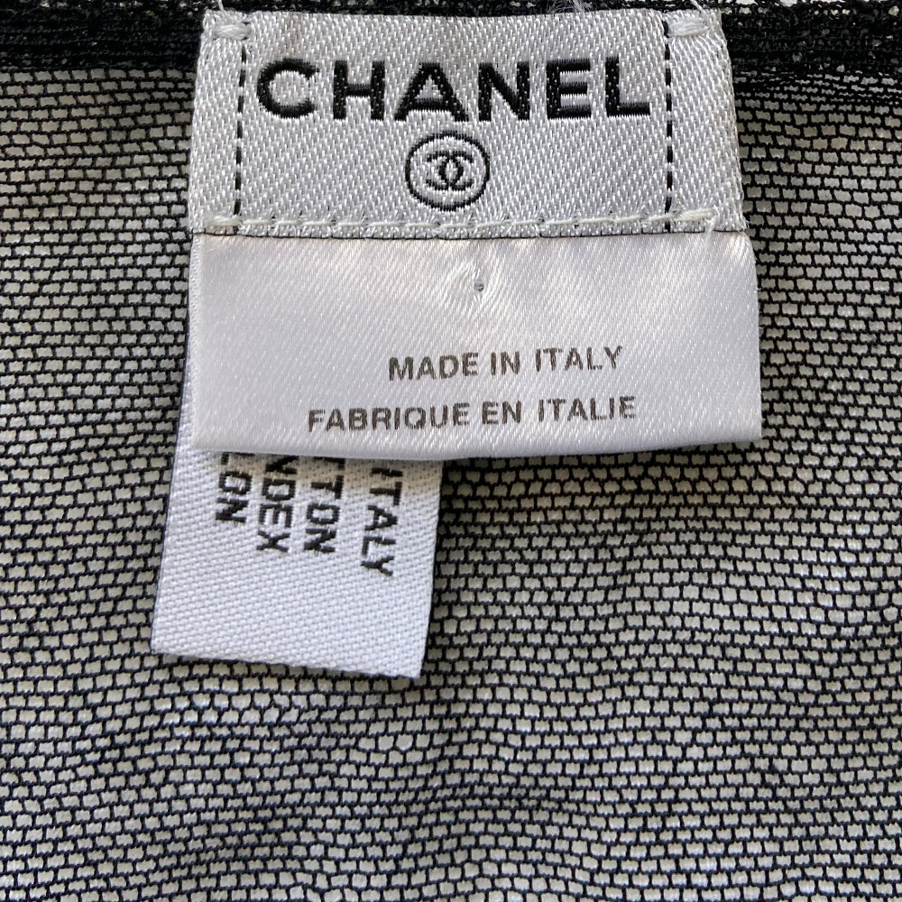 Chanel mesh embroidered tank from 2004 Spring RTW runway by Karl Lagerfeld for Chanel. Fine lined mesh fabric camisole with embroidered No 5 and interlocking CC logo embellishments scattered over the front and embroidered diamond pattern at bottom edge. Color: Black/white embroidery. Made in Italy 