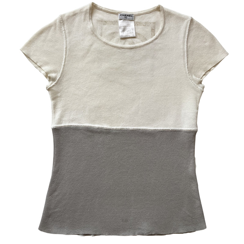 Chanel Logo Short Sleeve Knit top by Karl Lagerfeld for Chanel Spring 2001. Short sleeved two-tone color block fine rib knit with rounded ribbed edge neckline and larger ribbing at sleeves Interlocking box CC logo centered at upper back. 100% cotton in cream/grey Size: FR 36 